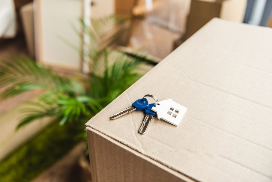 keys with a house keychain on top of box